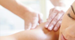 Close-up of a relaxed person receiving a deep tissue shoulder massage at Watford Sports Massage & Injury Clinic.
